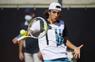 Lorenzo Musetti hitting a backhand
